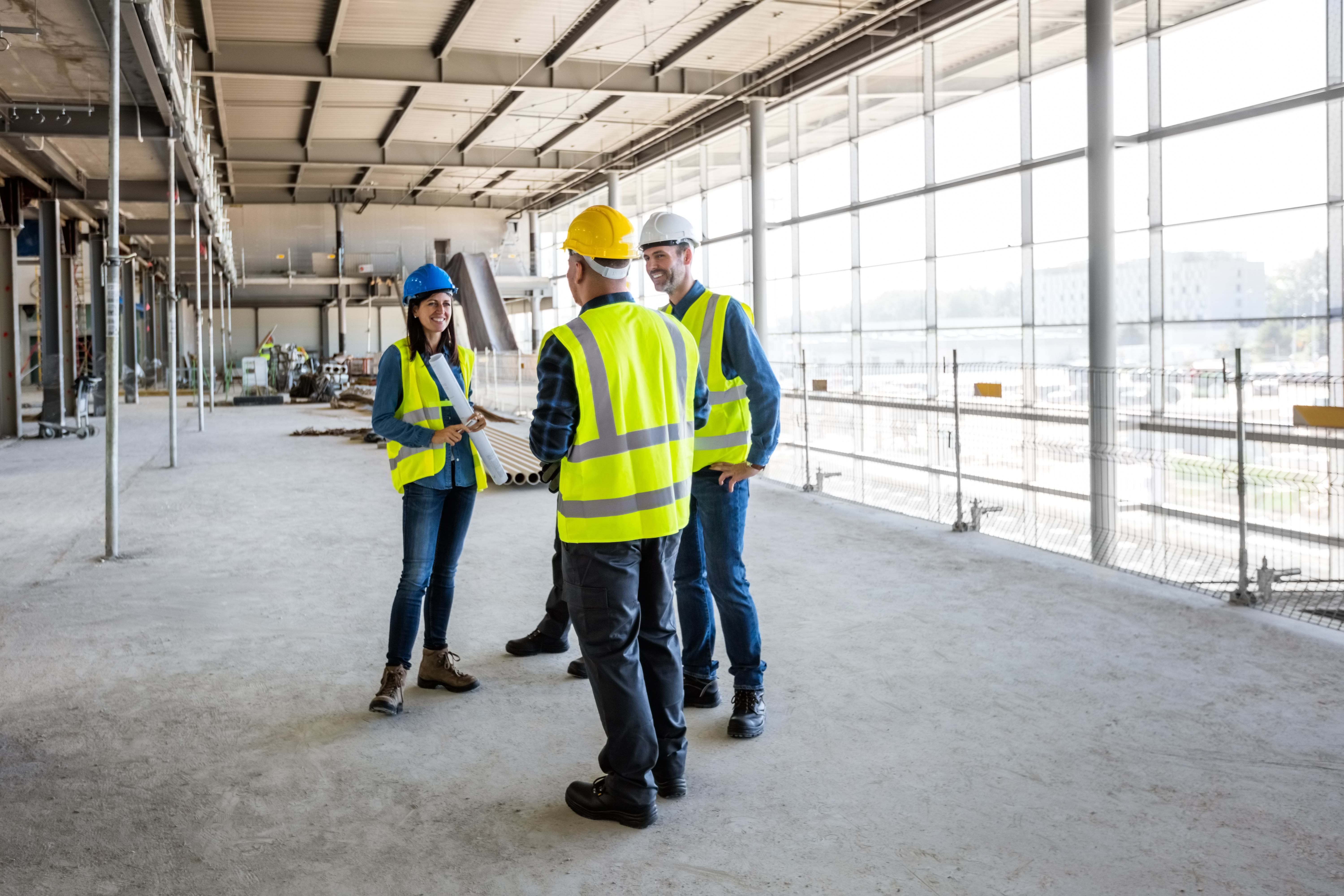 Architect talking with team at construcion site