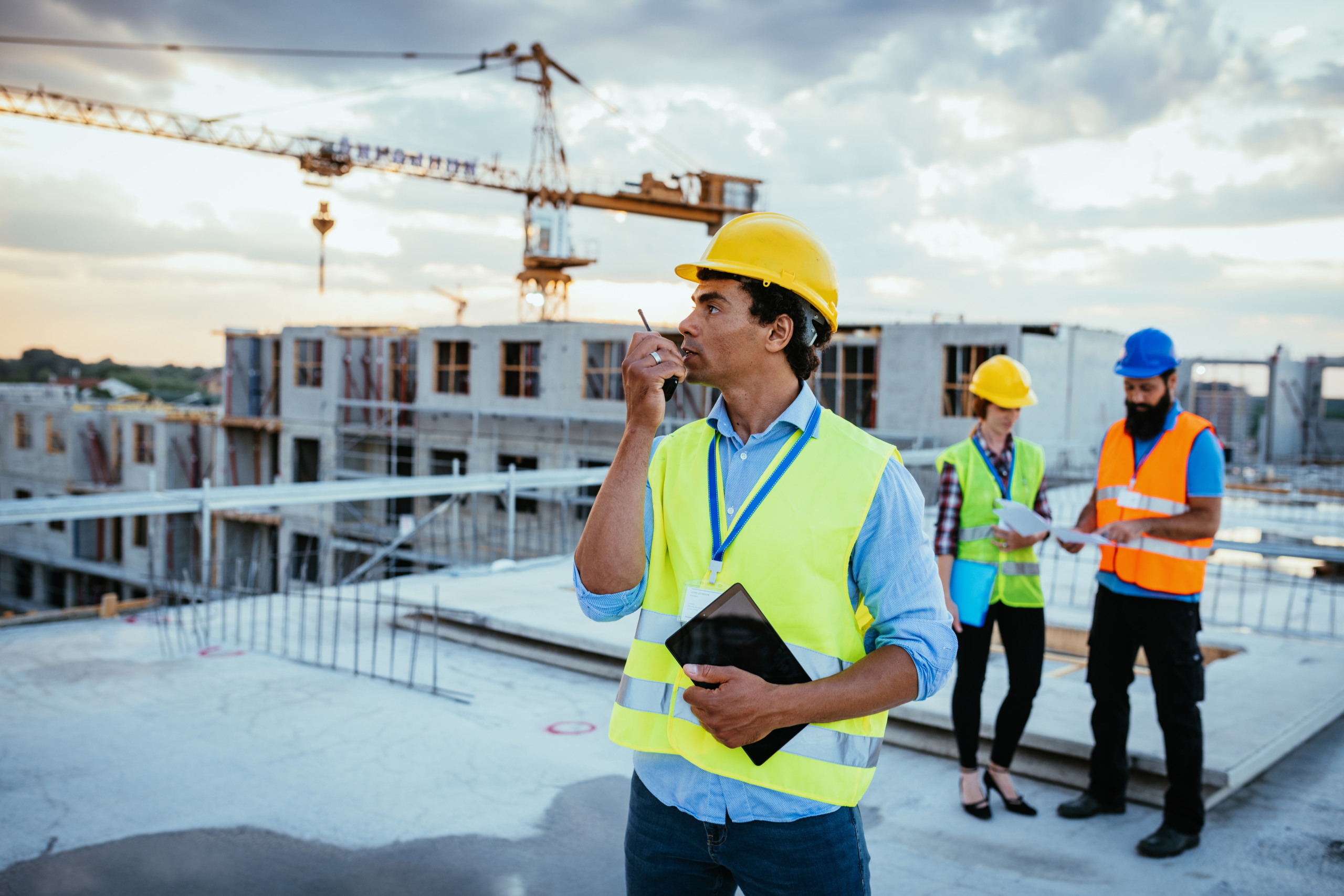 Shift manager using walkie talkie on construction site